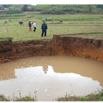 a-group-of-people-standing-near-a-puddle-descript